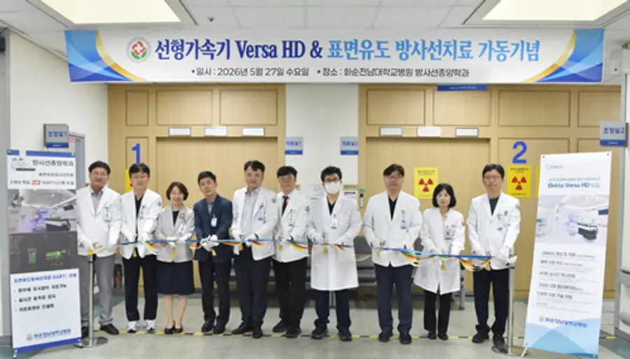 (사진-2) 화순전남대학교병원이 5월 27일 방사선종양학과 외래에서 첨단 선형가속기 ‘Versa HD’ 및 표면유도방사선치료(SGRT) 시스템 가동 기념식을 개최한 가운데 이완식 병원장과 주요 보직자, 의료진이 테이프 커팅을 하고 있다.